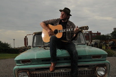 Jason Eady sitting on the hood of a car, aka the picture I'm not removing if you pay me